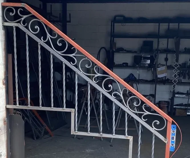 Metal staircase railing being welded at the Navarro Metalworks welding workshop